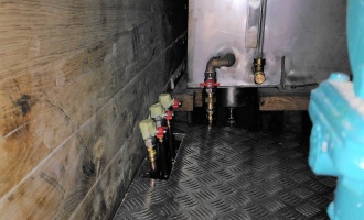 engine room floor and connections, in the background diesel tank with level indicator